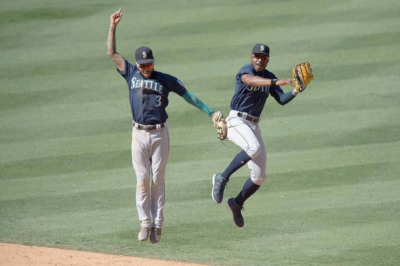 Seattle Mariners shortstop J.P. Crawford, left, and center fielder Kyle Lewis celebrate the team’s win over the Los Angeles Angels in a Monday baseball game in Anaheim, Calif. (Kyusung Gong/The Associated Press)