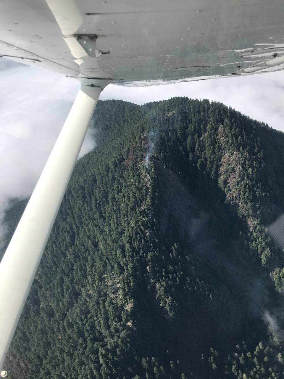 A reconnaissance flight observes a fire at Mount Lena in Olympic National Forest smoking this weekend. (National Park Service)
