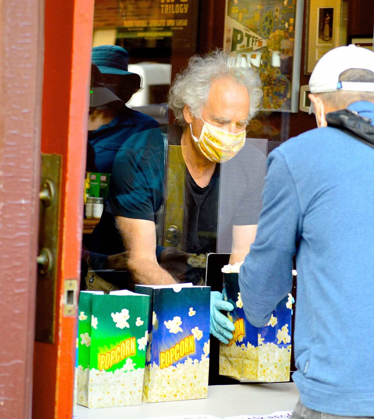 Rose Theatre owner Rocky Friedman becomes a popcorn vendor Saturday afternoons at his theater on Port Townsend’s Taylor Street. (Diane Urbani de la Paz/for Peninsula Daily News)