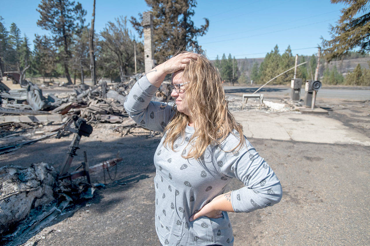 Hollie Jordan surveys her fathers service station that was destroyed by a wildfire on Tuesday in Malden, Wash. This was filled with work and life and memories, and its all gone, said Jordan. (Jed Conklin/Associated Press)