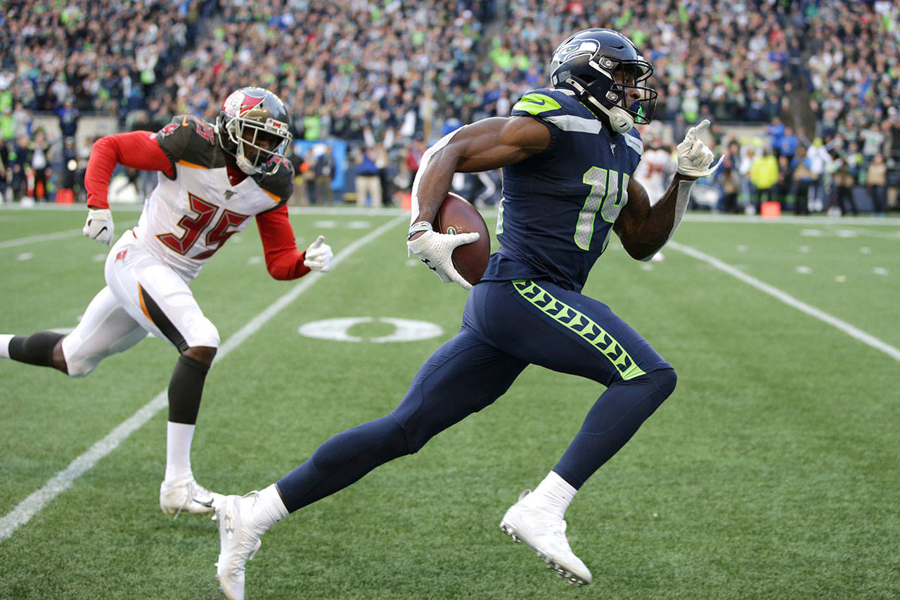 Seattle Seahawks wide receiver DK Metcalf, right, runs to score a touchdown ahead of Tampa Bay Buccaneers defensive back Jamel Dean during the second half of an NFL football game Sunday, Nov. 3, 2019, in Seattle. Metcalf didn’t disappoint in his rookie season even after sliding in the draft. It’s raised the expectations for what many are expecting to be a breakout season for Seattle’s second-year wide receiver. (Scott Eklund/Associated Press file)