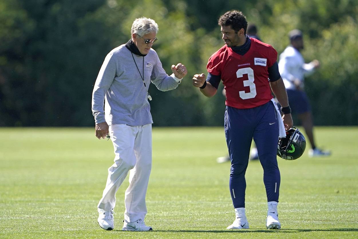 Seattle Seahawks quarterback Russell Wilson (3) bumps fists with head coach Pete Carroll after the last day of NFL football training camp Thursday in Renton. (AP Photo/Ted S. Warren)