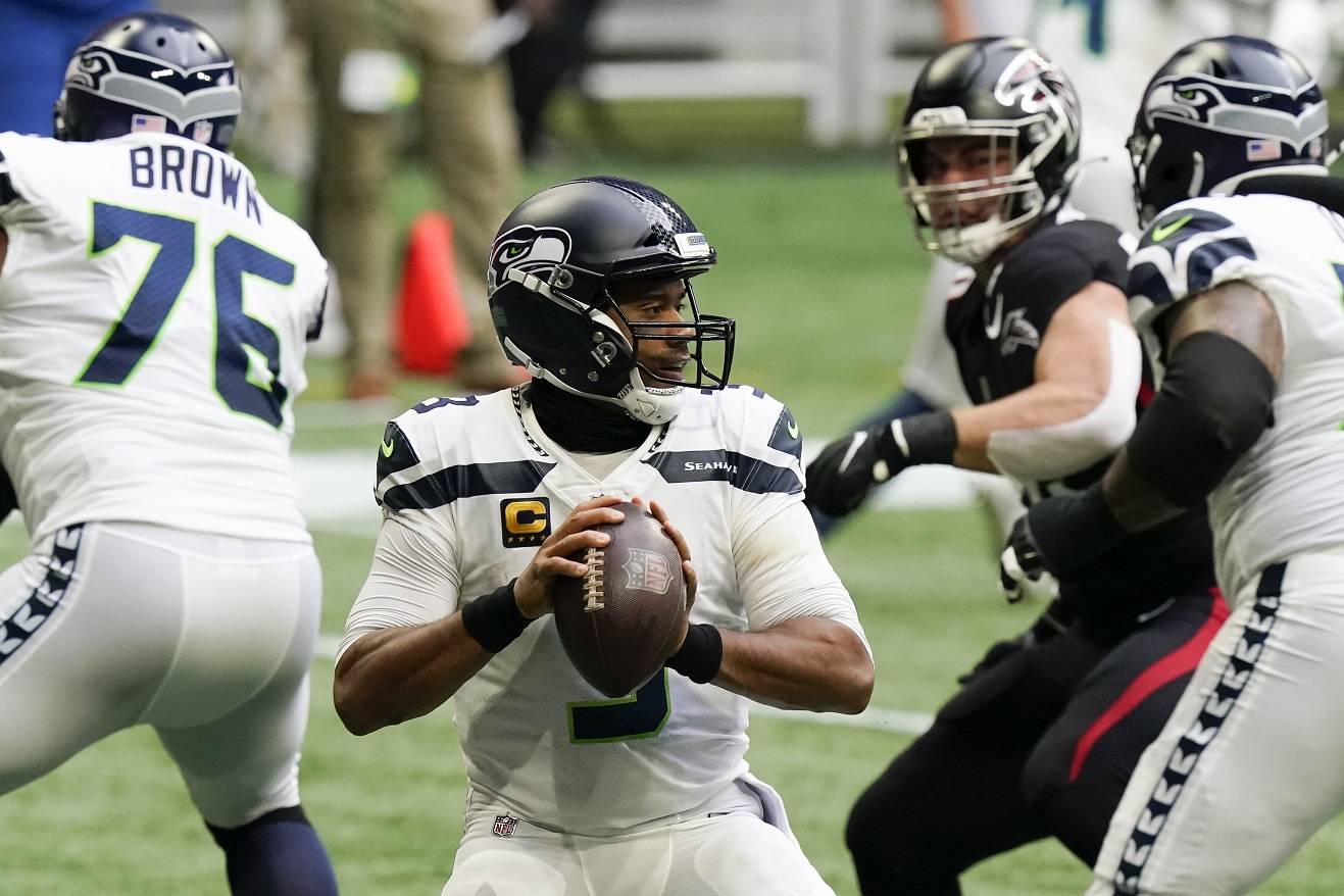 Seattle Seahawks quarterback Russell Wilson works in the pocket against the Atlanta Falcons during the first half Sunday in Atlanta. (Brynn Anderson/Associated Press)