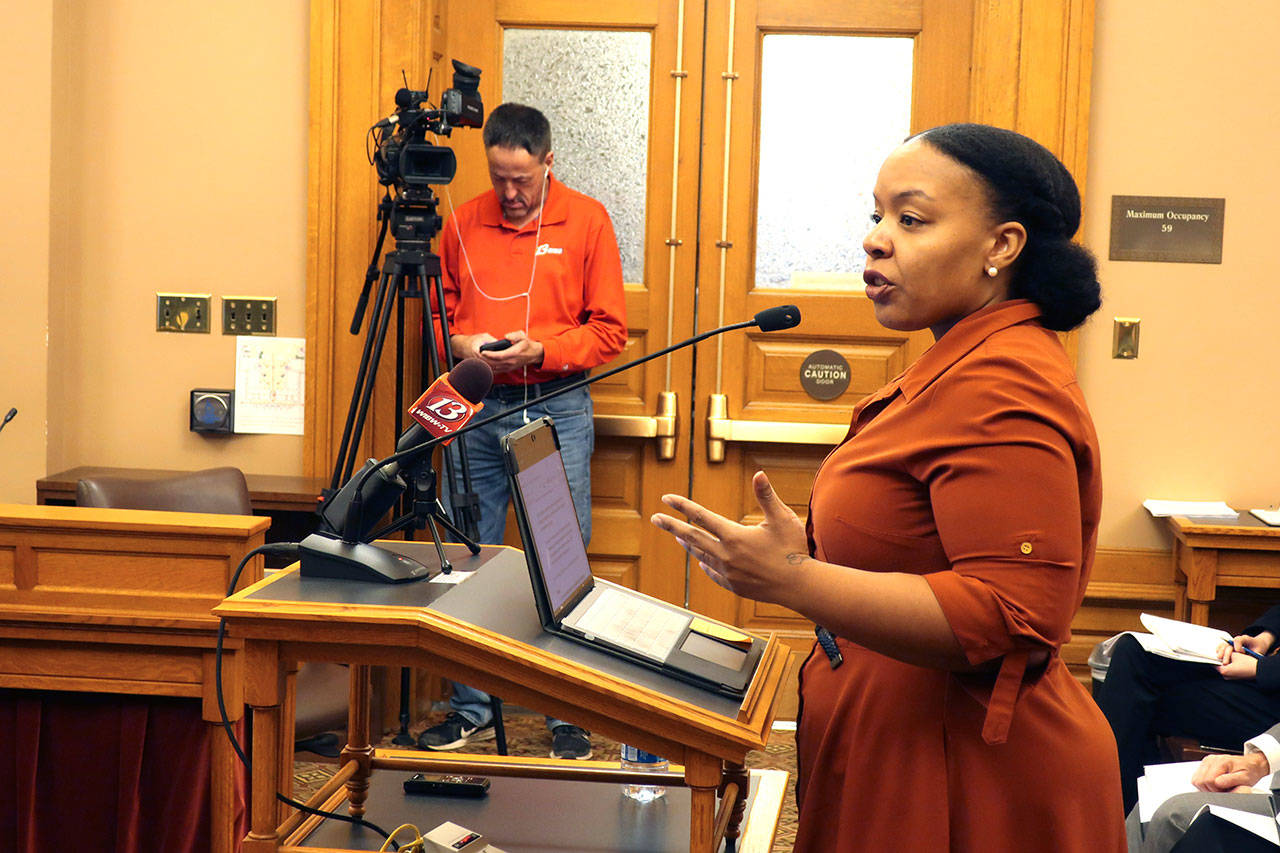 In this Jan. 28, 2020, file photo, Michele Watley, founder of Shirley’s Kitchen Cabinet, testifies in favor of a bill before the Kansas Legislature to ban discrimination based on hairstyles in employment, housing and public accommodations during a committee hearing at the Statehouse in Topeka, Kansas. A growing number of states, like New Mexico, are facing pressure to ban race-based discrimination against hair texture and hairstyles in schools and in the workplace. (John Hanna/Associated Press file)