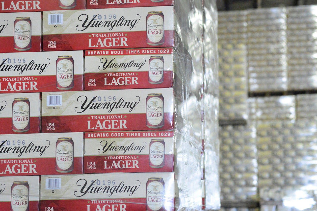 Cases of canned Yuengling Traditional Lager are stacked in the warehouse of the D.G. Yuengling & Son Brewery Mill Creek plant on Tuesday, July 21, 2020, in Pottsville, Pa. Pottsville, Pennsylvania-based D.G. Yuengling and Son Inc. said Tuesday, Sept. it’s forming a joint venture with Molson Coors Beverage Co. to expand distribution of its beers beyond the East Coast. Yuengling, a 191-year-old family-owned brewery known for its cheap German-style lager, will remain independent. (Lindsey Shuey/Republican-Herald via AP, File)