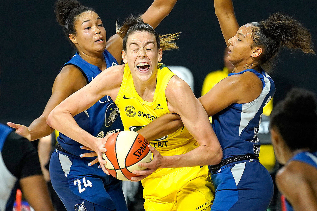 Seattle Storm forward Breanna Stewart (30) gets fouled by Minnesota Lynx forward Mikiah Herbert Harrigan (21) during the second half of Game 3 of a WNBA basketball semifinal round playoff series Sunday in Bradenton, Fla. Looking on is Lynx forward Napheesa Collier (24). (AP Photo/Chris OMeara)