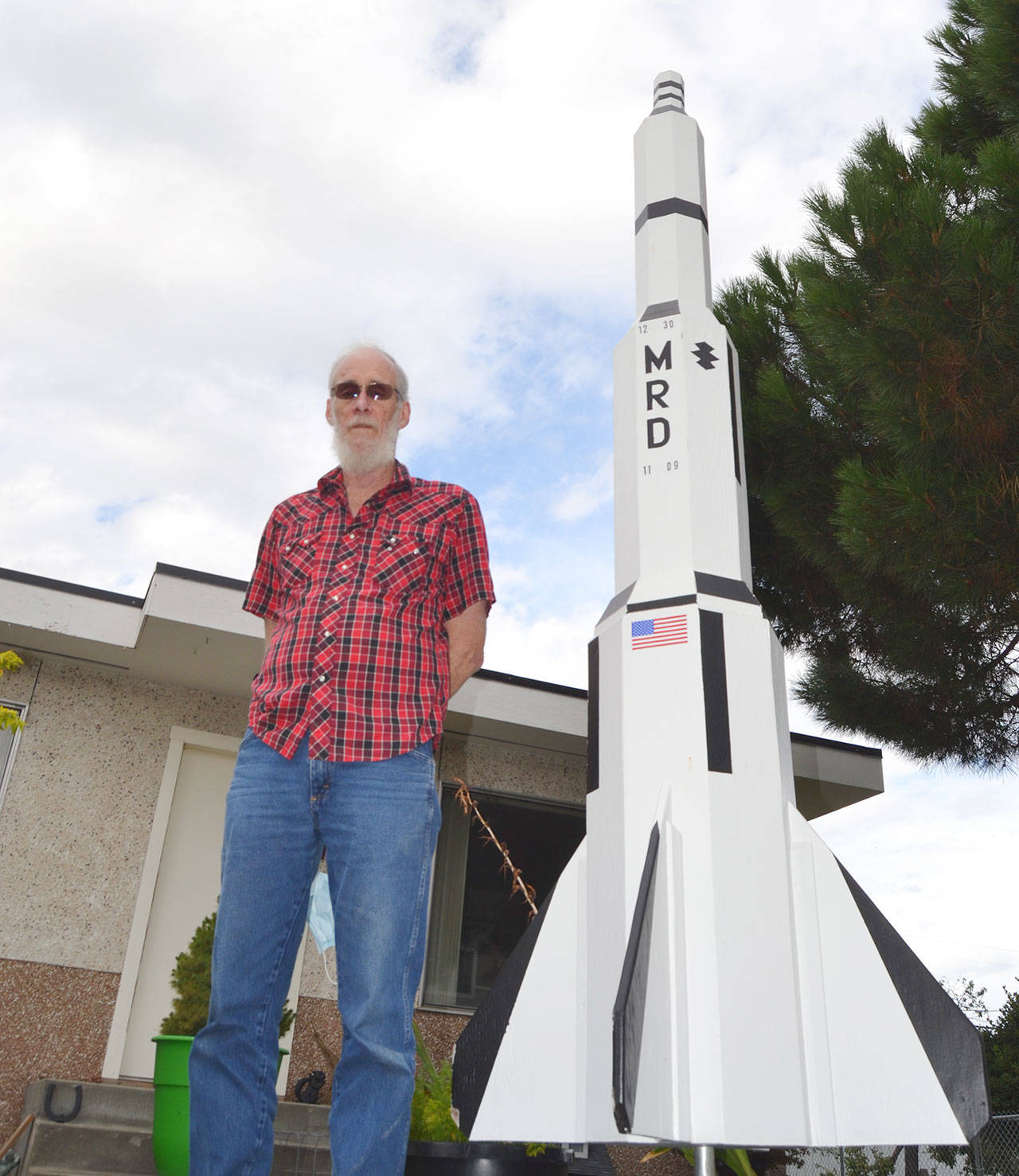 Driving along West Cedar Street, passersby can see Ron DeGroat’s wooden Saturn V replica. The model with its cement base is more than 9 feet tall and sits outside year-round. (Matthew Nash/Olympic Peninsula News Group)