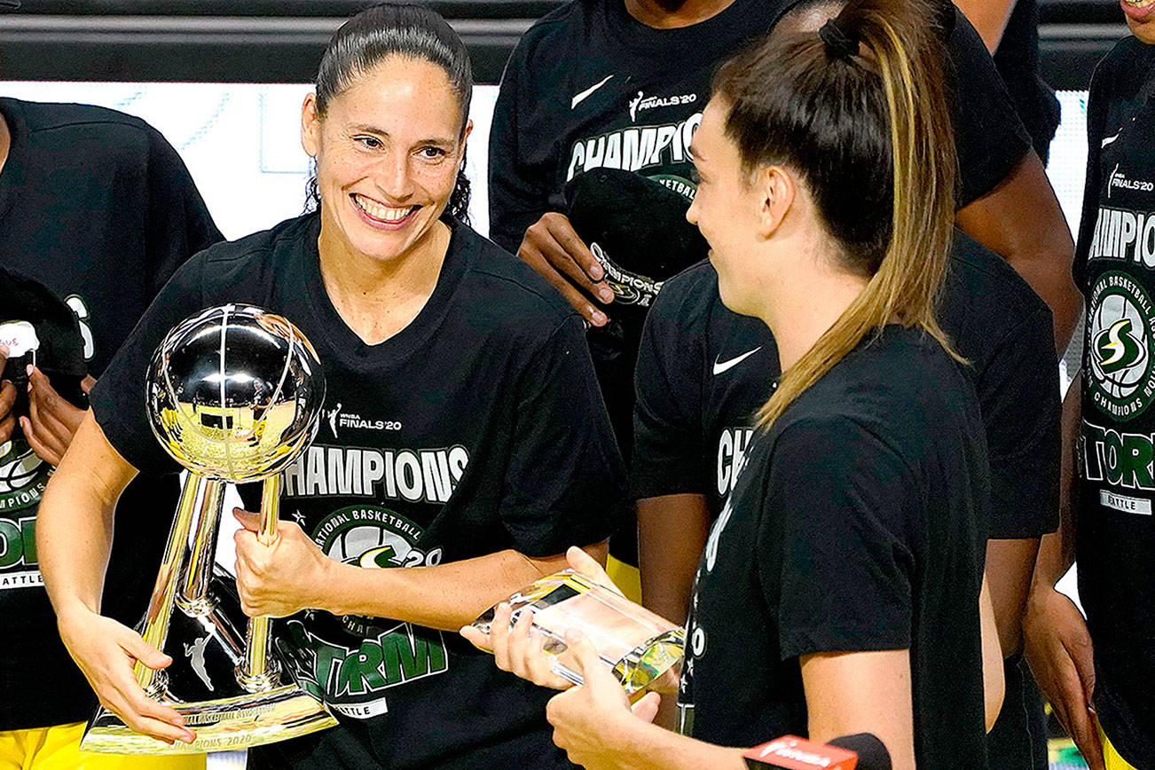 Seattle Storm guard Sue Bird, left, smiles at Breanna Stewart after the team defeated the Las Vegas Aces to win basketball's WNBA championship Tuesday, Oct. 6, 2020, in Bradenton, Fla. (AP Photo/Chris O'Meara)
