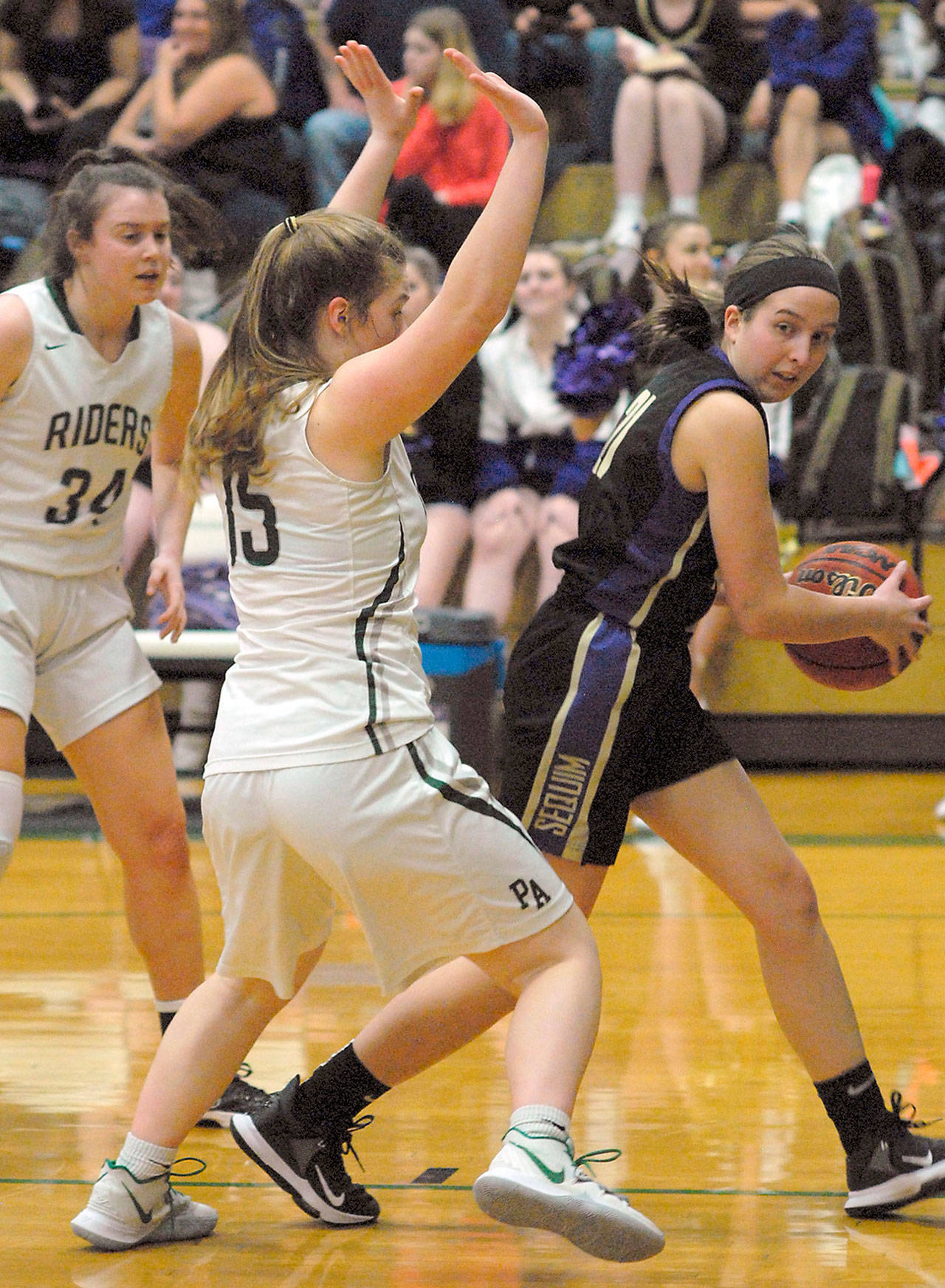 Sequim’s Kalli Wiker, right, gets trapped at the line by Port Angeles’ Myra Walker as Walker’s teammate Jaida Wood, left, looks on during game in Port Angeles. (Keith Thorpe/Peninsula Daily News file)