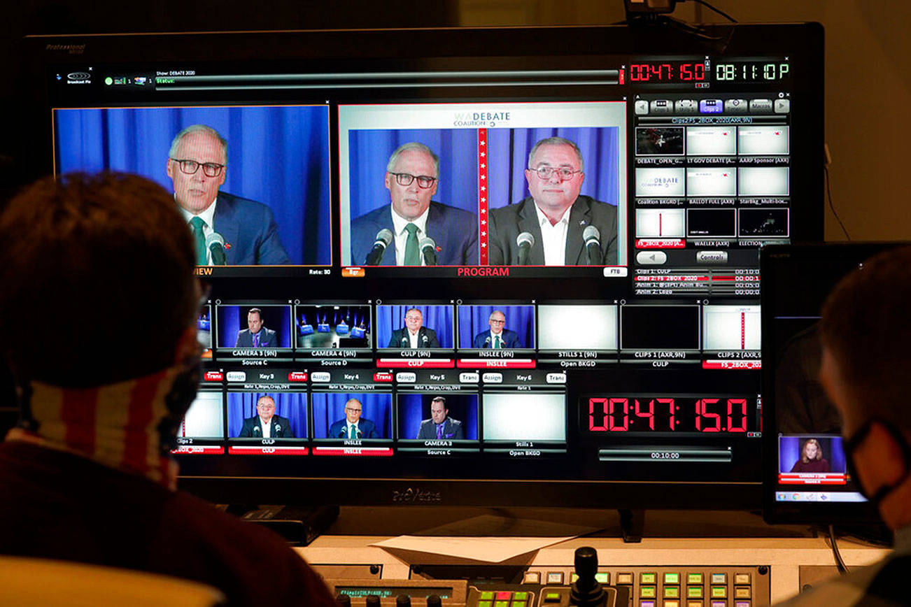 Washington gubernatorial candidates Gov. Jay Inslee, a Democrat, center-left, and Loren Culp, a Republican, center-right, are shown on a monitor in a video control room at the studios of TVW, Wednesday, Oct. 7, 2020, in Olympia, Wash., as they take part in a debate. Due to concerns over COVID-19, each candidate took part in the debate from individual rooms separate from moderators. (AP Photo/Ted S. Warren)