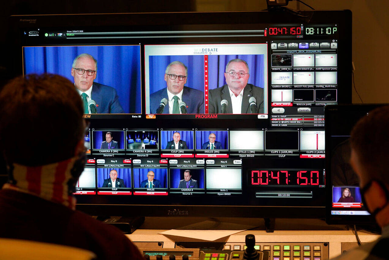 Washington gubernatorial candidates Gov. Jay Inslee, a Democrat, center-left, and Loren Culp, a Republican, center-right, are shown on a monitor in a video control room at the studios of TVW on Wednesday, Oct. 7, 2020, in Olympia as they take part in a debate. Due to concerns over COVID-19, each candidate took part in the debate from individual rooms separate from moderators. (Ted S. Warren/Associated Press)