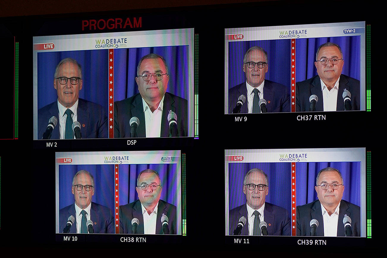 Washington gubernatorial candidates Gov. Jay Inslee, a Democrat, left, and Loren Culp, a Republican, right, are shown on a monitor in a video control room at the studios of TVW, Wednesday, Oct. 7, 2020, in Olympia, Wash., as they take part in a debate. Due to concerns over COVID-19, each candidate took part in the debate from individual rooms separate from moderators. (AP Photo/Ted S. Warren)