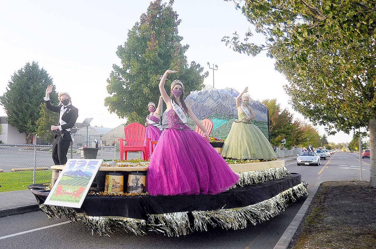 From left, royalty prince Logan Laxson, princess Brii Hingtgen, princess Alicia Pairadee and queen Lindsey Coffman wave to a virtual crowd on Sequim-Dungeness Way during the Sequim Irrigation Festival’s makeshift Grand Parade on Saturday. (Michael Dashiell/Olympic Peninsula News Group)