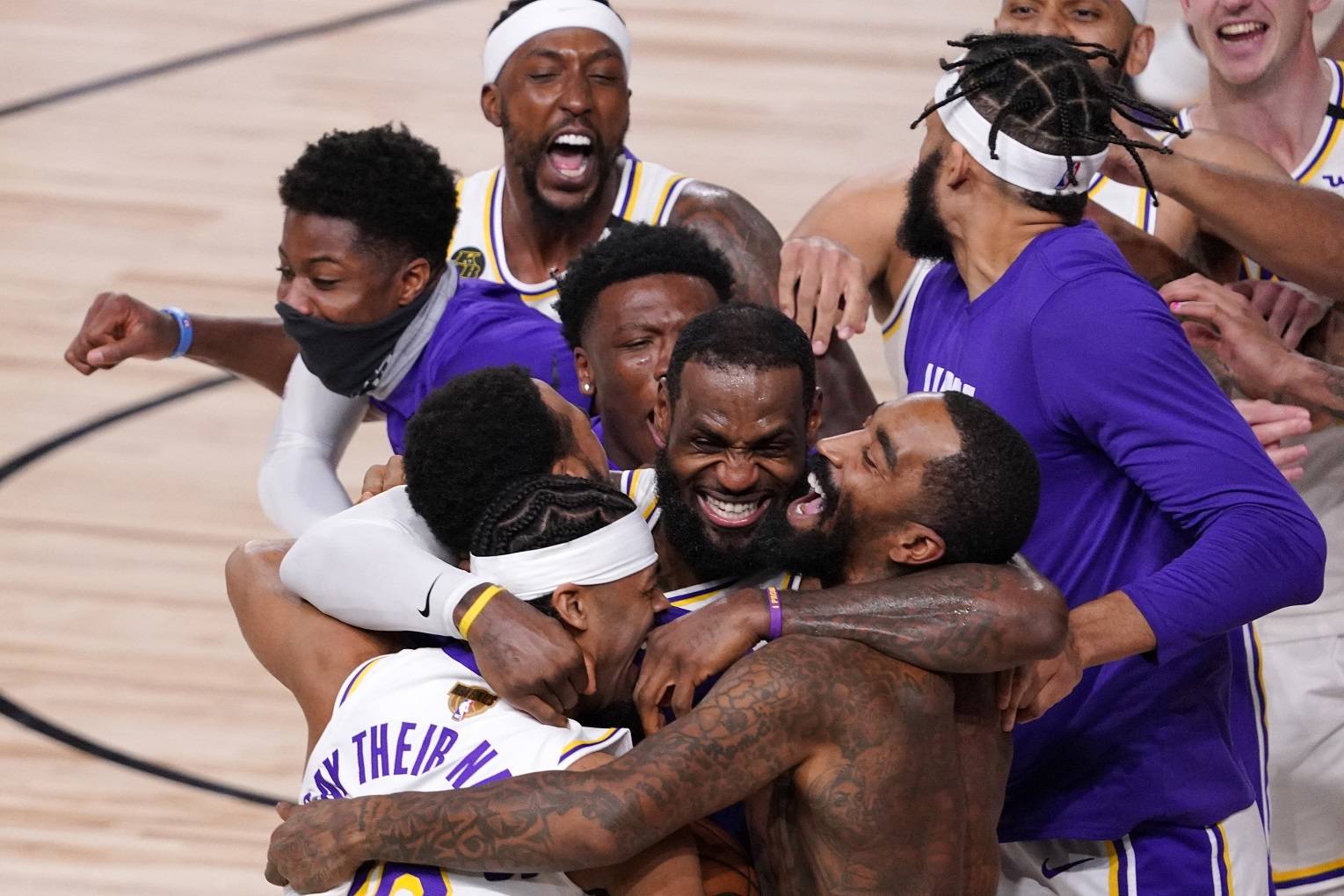 The Los Angeles Lakers’ LeBron James (23) celebrates with his teammates after the Lakers defeated the Miami Heat 106-93 in Game 6 of basketball’s NBA Finals Sunday in Lake Buena Vista, Fla. (Mark J. Terrill/Associated Press)