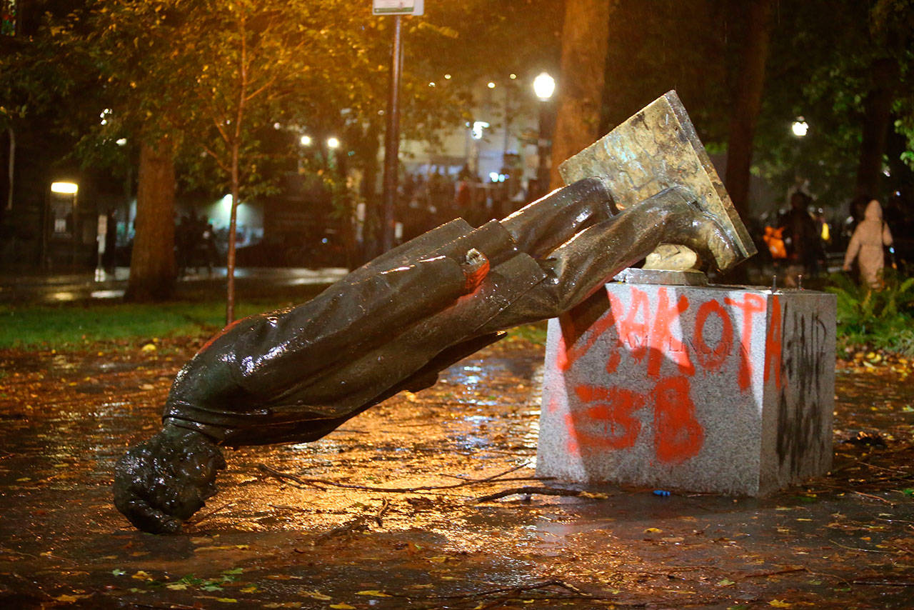 A group of protesters toppled statues of former presidents Theodore Roosevelt and Abraham Lincoln in Portland’s South Park Block late Sunday, Oct. 11, 2020. (Sean Meagher/The Oregonian via AP)