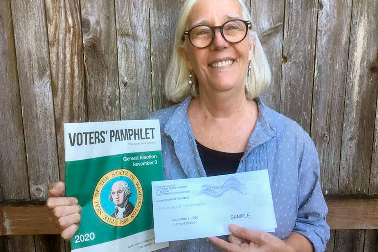 Janette Force, executive director of the Port Townsend Film Festival, holds a sample ballot and a state-produced Voters' Pamphlet. Submitted photo