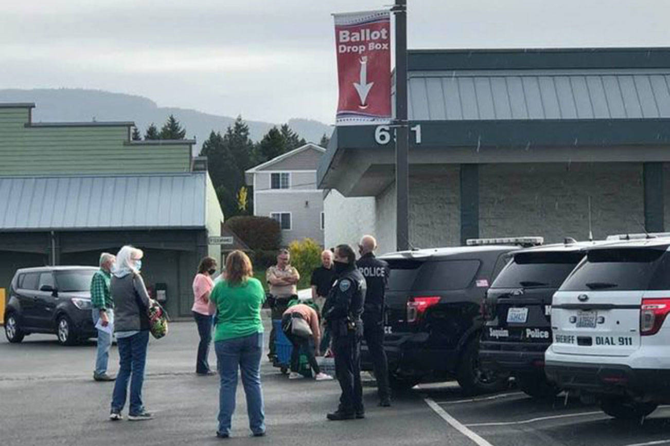 Residents await the collection of ballots from the JCPenney parking lot at 651 W. Washington St. on Saturday, Oct. 17, 2020. Early returns filled at least two Clallam County drop boxes to capacity last week. (Photo courtesy of Barb Hanna)