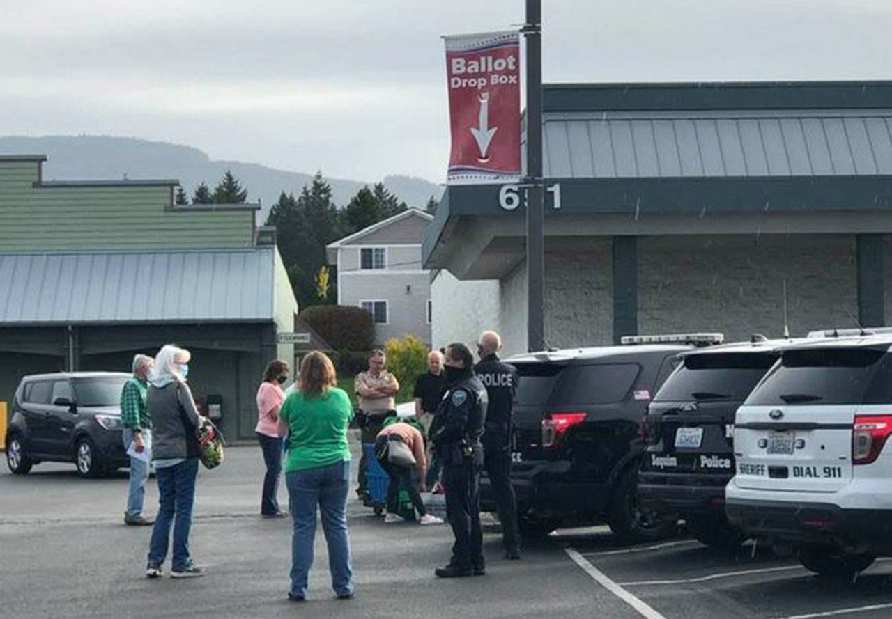 Residents await the collection of ballots from the JCPenney parking lot at 651 W. Washington St. on Saturday, Oct. 17, 2020. Early returns filled at least two Clallam County drop boxes to capacity last week. (Photo courtesy of Barb Hanna)
