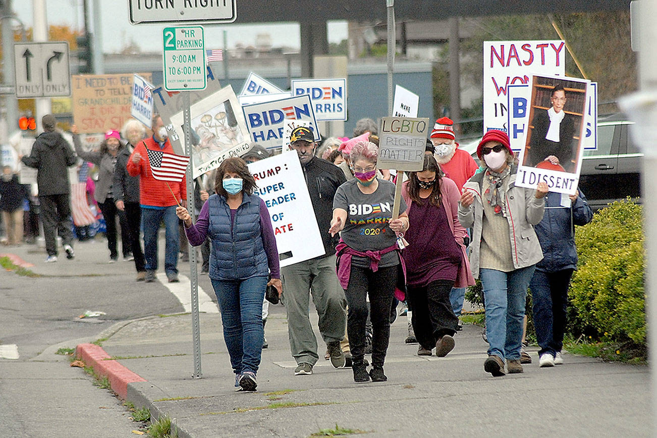 Keith Thorpe/Peninsula Daily NewsMarchers celebrating the legacy of the late Supreme Court Justice Ruth Bader Ginsberg make their way up Lincoln Street to the Clallam County Courthouse after a procession through downtown Port Angeles on Saturday. A crowd of nearly 300 people took part in the demonstration, which also served as a protest of the policies of President Donald Trump..