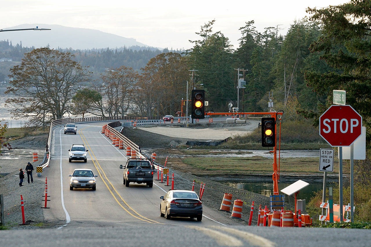 Vehicles travel in both directions Thursday evening along the recently completed state Highway 116 bridge between Indian and Marrowstone islands. (Nicholas Johnson/Peninsula Daily News)