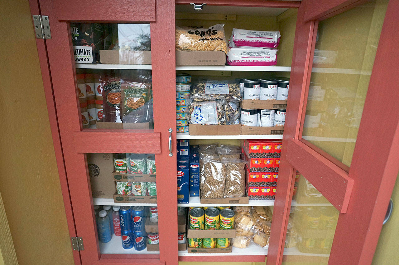 A pantry outside the Port Townsend Food Bank is stocked with non-perishable food items free for the taking at the corner of Blaine and Walker streets in Port Townsend. (Nicholas Johnson/Peninsula Daily News)