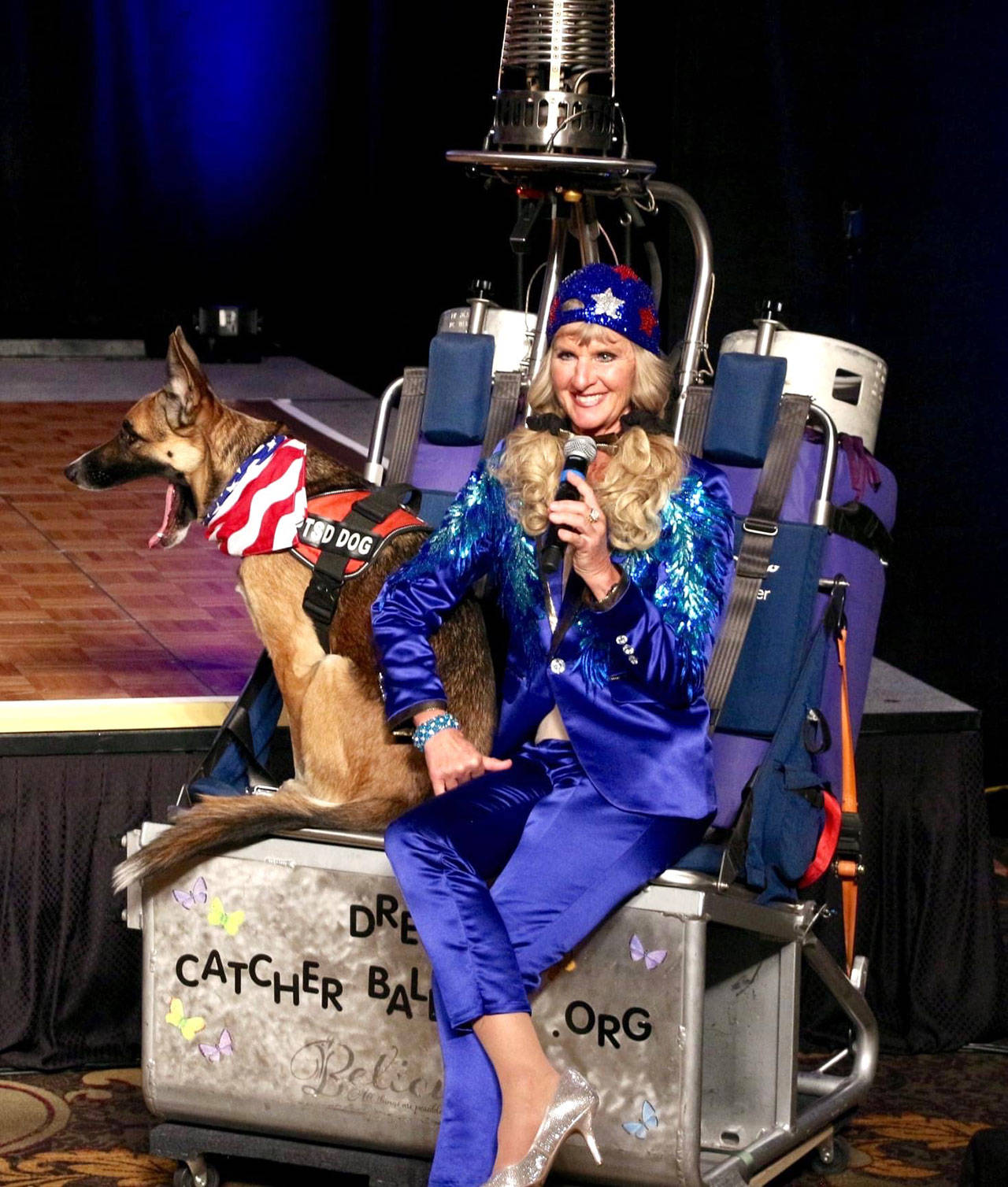 Captain-Crystal Stout, with her therapy dog Lucee Light, speaks to judges and audience members about her Dream Catcher Balloon Program on Oct. 8 during the Ms. Senior United States pageant. She received the title that night. (Photo courtesy of Captain-Crystal Stout)