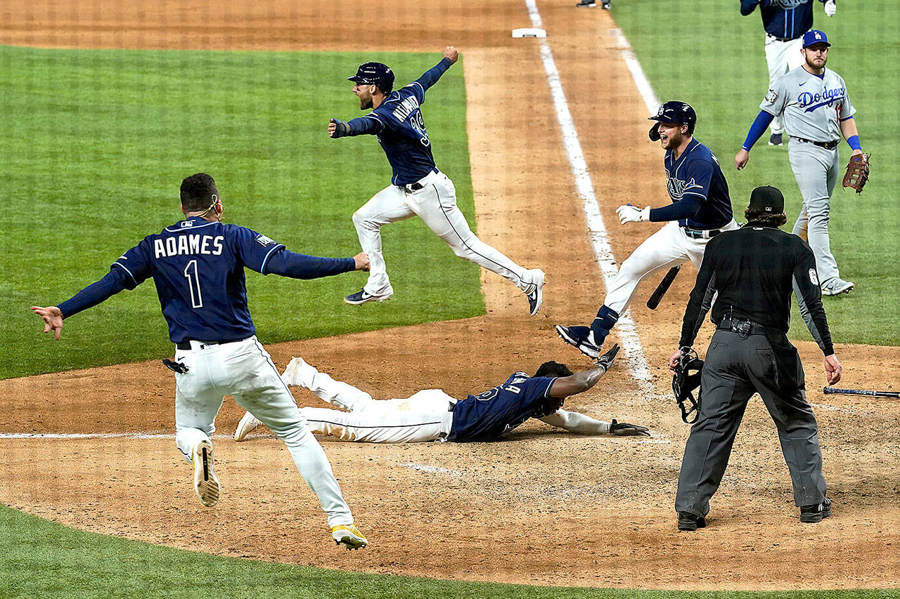 Tampa Bay players celebrate winning in Game 4 of the baseball World Series Saturday night in Arlington, Texas. Rays defeated the Dodgers 8-7 to tie the series 2-2 games. (AP Photo/Eric Gay)