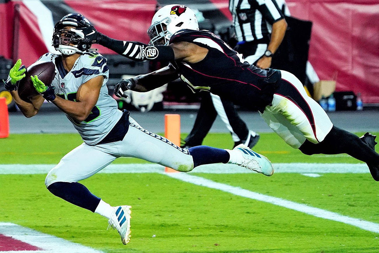 Seattle Seahawks wide receiver Tyler Lockett (16) pulls in a touchdown catch as Arizona Cardinals cornerback Patrick Peterson defends during the first half of an NFL football game, Sunday, Oct. 25, 2020, in Glendale, Ariz. (AP Photo/Rick Scuteri)