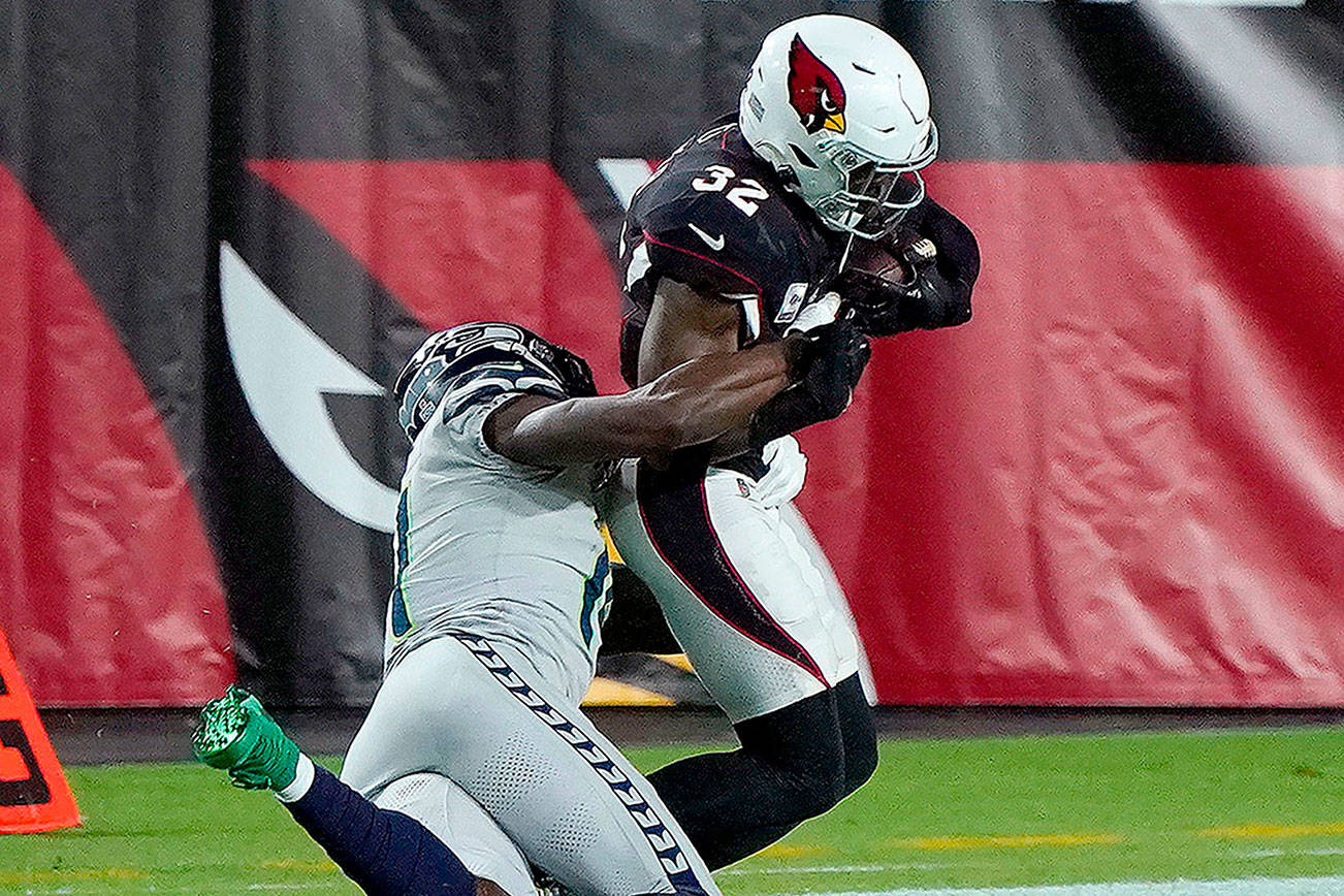 Seattle Seahawks wide receiver DK Metcalf tackles Arizona Cardinals strong safety Budda Baker (32) short of the goal line after Baker intercepted a pass during the first half of an NFL football game, Sunday, Oct. 25, 2020, in Glendale, Ariz. (AP Photo/Rick Scuteri)