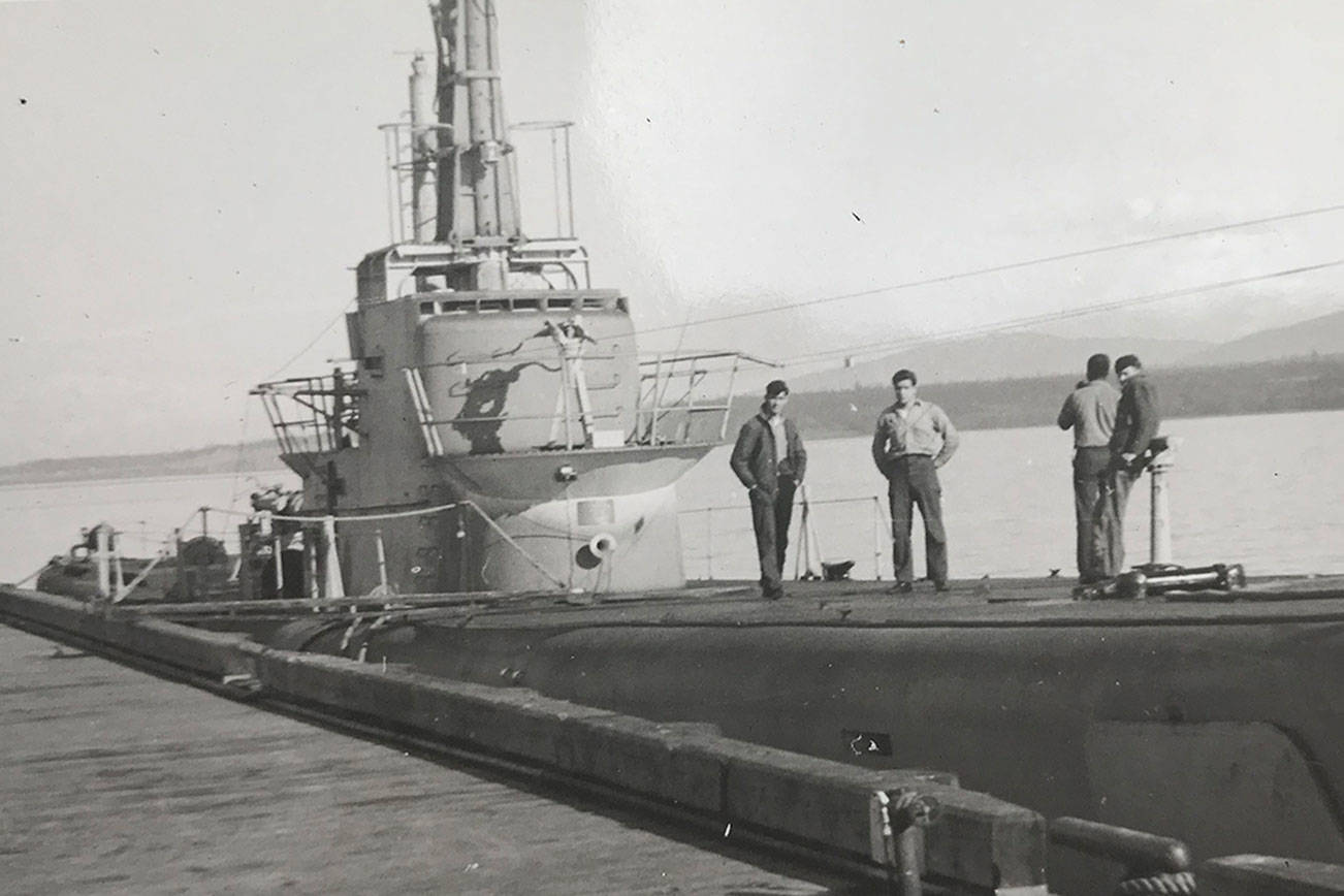 Tambor docked at Coast Guard Air Station.   No identity for the men.   Source: Nancy VanSickle collection