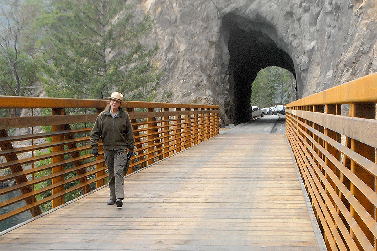 Keith Thorpe/Peninsula Daily News
Olympic National Park Superintendent Sarah Creachbaum walks across a new bridge on the Spruce Railroad Trail abutting the recently renovated Daley-Rankin Tunnel at the start of a ceremony on Thursday to celebrate the soon-to-be-open trail on the north shore of Lake Crescent.