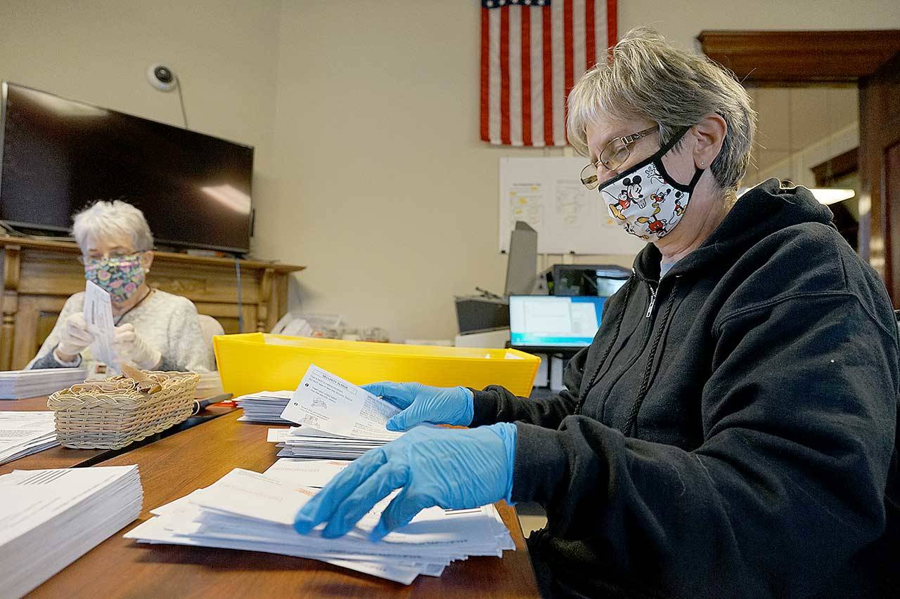 Mary Tyburski, right, and Betty Grewell of Port Townsend open and sort ballots Monday, Nov. 2, 2020, in the Jefferson County Auditor’s Office at the Jefferson County Courthouse in Port Townsend. (Nicholas Johnson/Peninsula Daily News)
