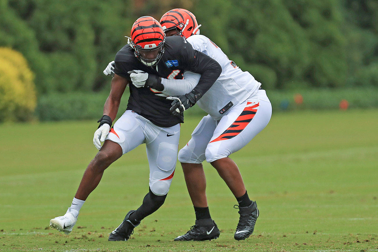 Cincinnati Bengals' Carlos Dunlap, left, rushes against Fred Johnson, right, during an NFL football camp practice in Cincinnati, Tuesday, Aug. 18, 2020. (AP Photo/Aaron Doster)