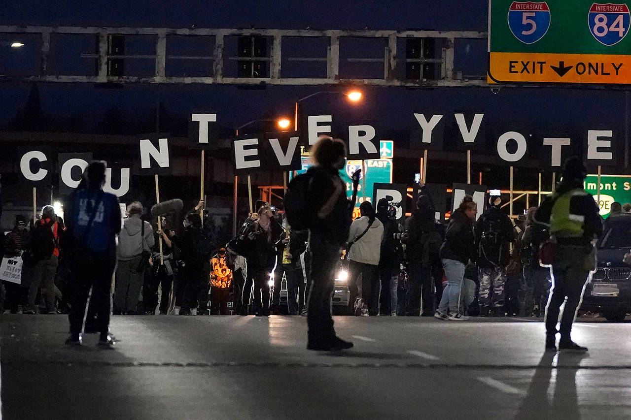 Protesters hold letters that spell Count Every Vote as they cross an overpass while marching in Portland, Ore., on Wednesday, Nov. 4, 2020, following Tuesdays election. (Marcio Jose Sanchez/Associated Press)