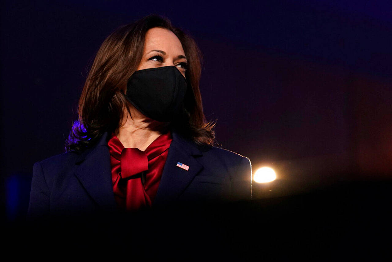 Kamala Harris, D-Calif., listens as Democratic presidential candidate former Vice President Joe Biden speaks Friday, Nov. 6, 2020, in Wilmington, Del. Harris made history as the first Black woman to become vice president Saturday, Nov. 7, 2020. (Carolyn Kaster/Associated Press)