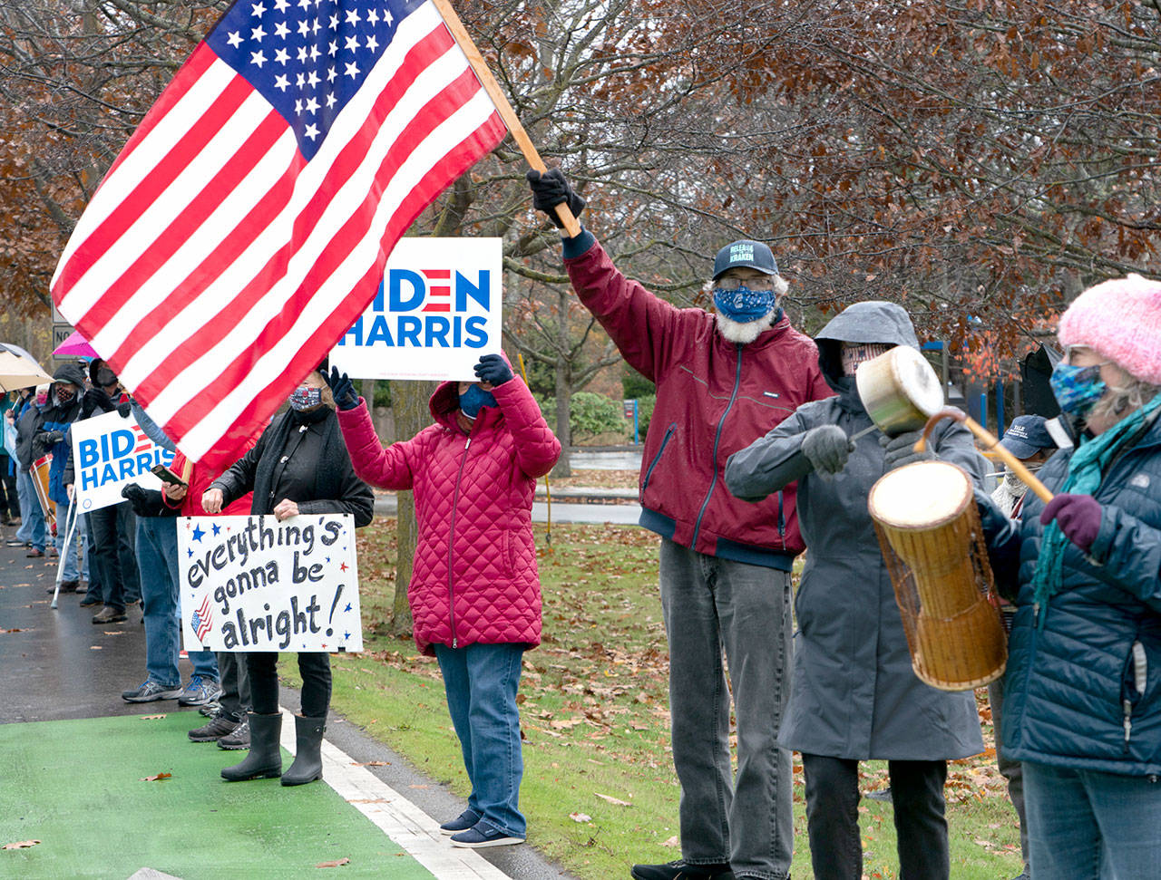 Nearly 200 showed up in the rain at all four corners of Kearney and Sims Way in Port Townsend on Saturday, Nov. 7, 2020, for an inpromptu rally to celebrate the media’s calling of Joe Biden as the next presidert of the United States. (Steve Mullensky/for Peninsula Daily News)