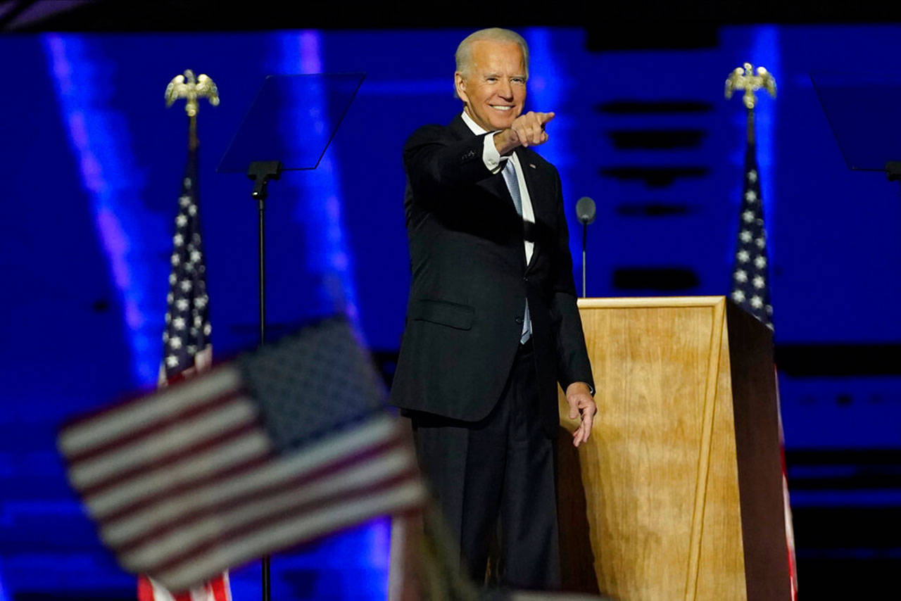 President-elect Joe Biden gestures on stage after speaking Saturday, Nov. 7, 2020, in Wilmington, Del. (Andrew Harnik/Associated Press/Pool)