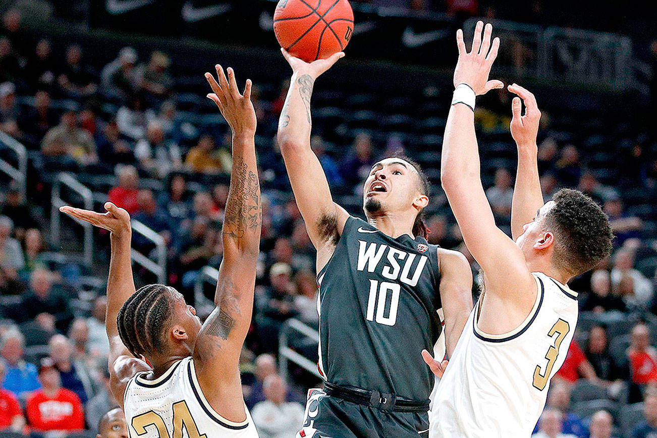 FILE - In this March 11, 2020, file photo, Washington State's Isaac Bonton (10) shoots over Colorado's Eli Parquet (24) and Maddox Daniels (3) during the first half of an NCAA college basketball game in the first round of the Pac-12 men's tournament in Las Vegas. The Cougars went 16-16 last year, 6-12 in the Pac-12, and won their first game in the Pac-12 tournament in a decade when they beat Colorado before the rest of the tournament was terminated because of the coronavirus. (AP Photo/John Locher, File)