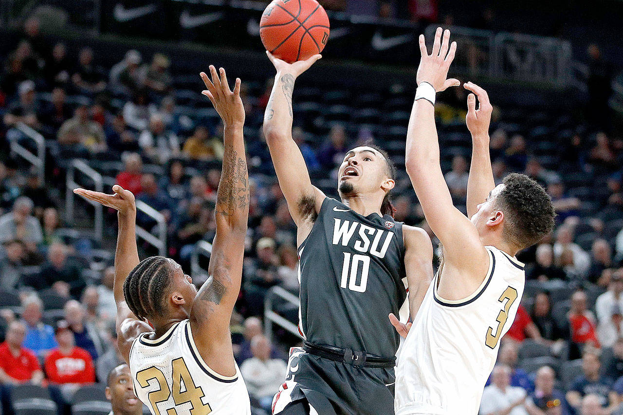 Washington State’s Isaac Bonton (10) shoots over Colorado’s Eli Parquet (24) and Maddox Daniels (3) during the first round of the Pac-12 men’s tournament in Las Vegas on March 11. The Cougars went 16-16 last year, 6-12 in the Pac-12, and won their first game in the Pac-12 tournament in a decade when they beat Colorado before the rest of the tournament was terminated because of the coronavirus. (John Locher/Associated Press)