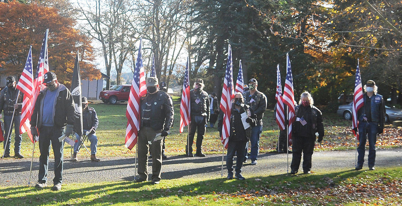 Members of the American Legion riders reflect as Jack Grennan Post 62 chaplain Nancy Zimmerman offers a prayer at the Sequim Veterans Day ceremony. (Michael Dashiell/Olympic Peninsula News Group)