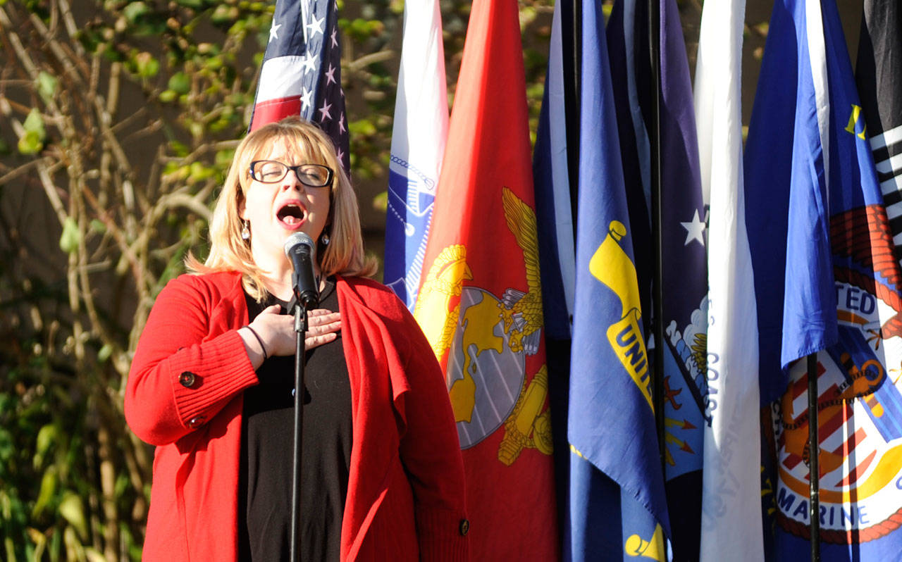 Amanda Bacon leads the National Anthem as part of the Veterans Day event at Pioneer Memorial Park on Wednesday. (Michael Dashiell/Olympic Peninsula News Group)