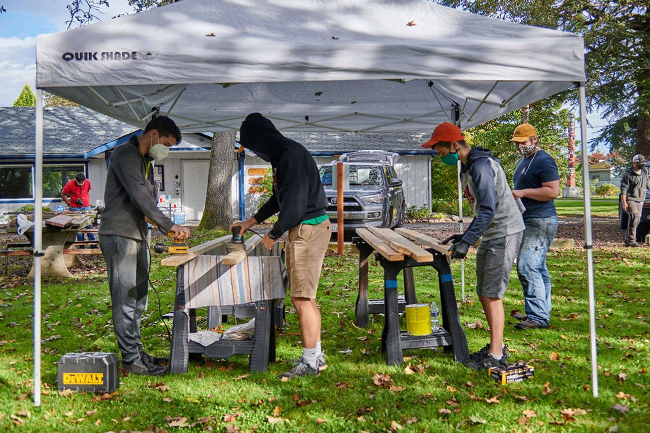 Scouts and other volunteers help complete refurbishing of six picnic tables at Pioneer Memorial Park, part of Calem Ryne Klinger’s Eagle Scout project. Photo courtesy of Sequim Prairie Garden Club