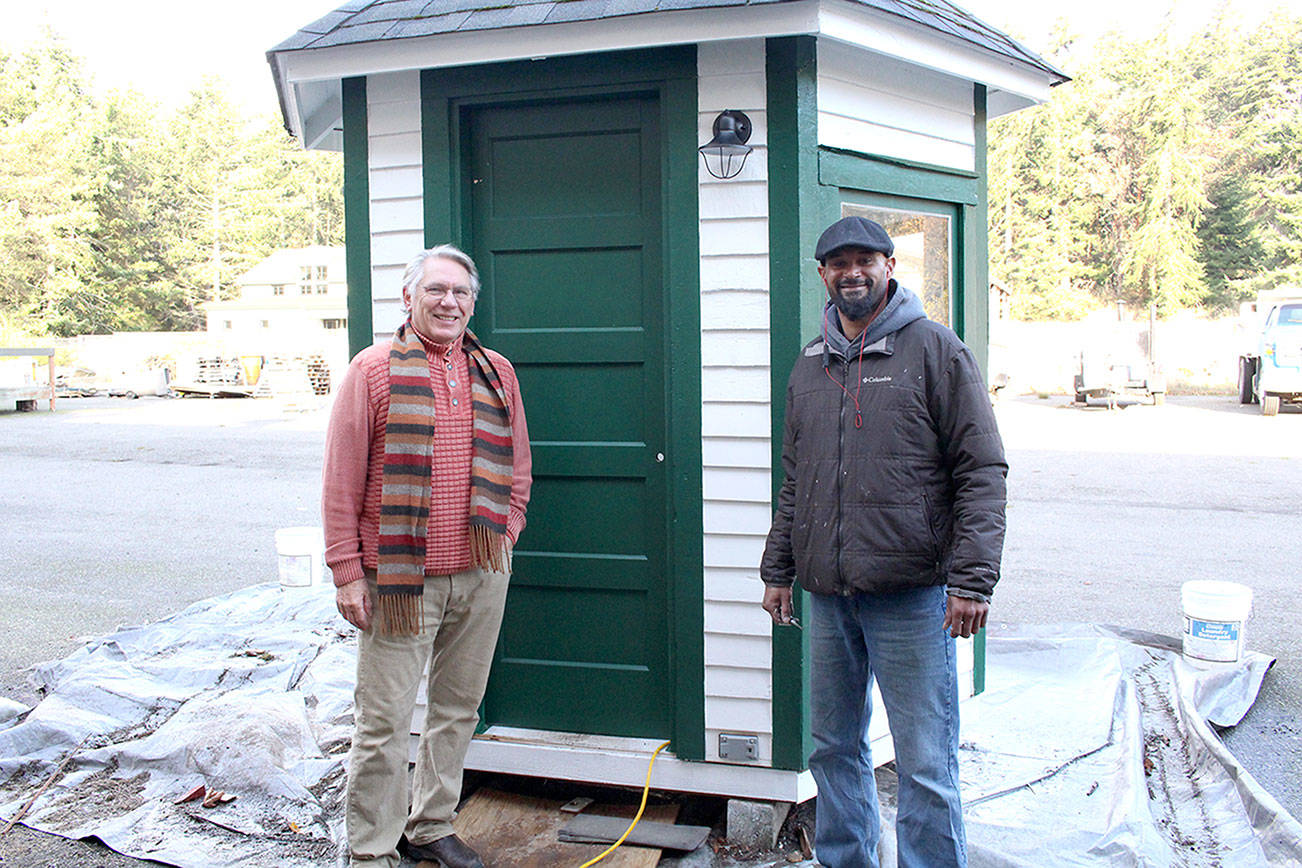 Friends of Fort Worden project lead and board member Bill Appleton, left, stands with local contractor Ty Hodge in front of the nearly completed restored guard shack that used to stand at the entrance of Fort Worden State Park when it was still used by the military. (Zach Jablonski/Peninsula Daily News)