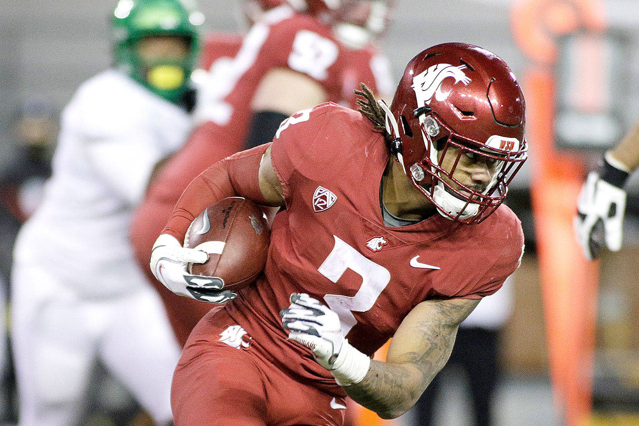 Washington State running back Deon McIntosh carries the ball during the second half against Oregon in Pullman on Saturday. Oregon won 43-29. (AP Photo/Young Kwak)