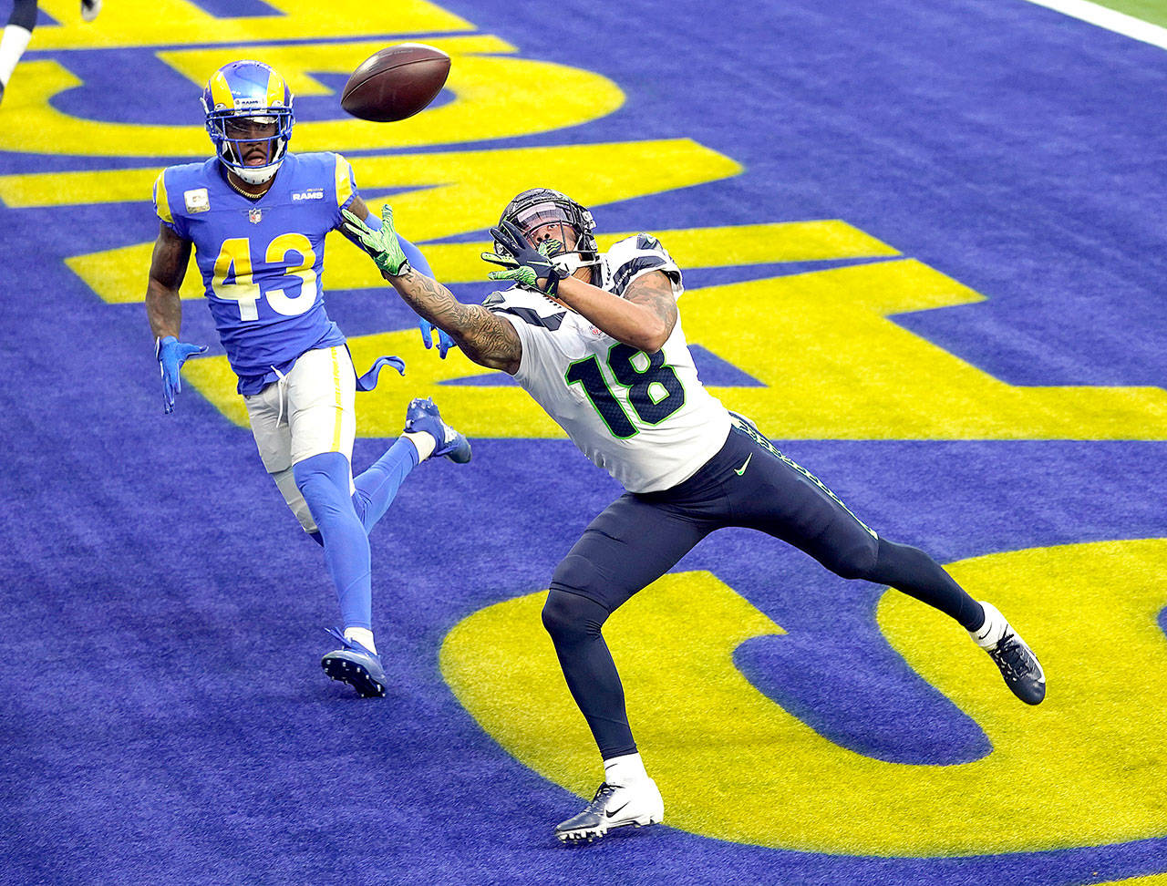 Seattle Seahawks wide receiver Freddie Swain reaches but can’t catch a pass in the end zone Sunday during the first half against Rams’ defender John Johnson III in Inglewood, Calif. (Ashley Landis/The Associated Press)