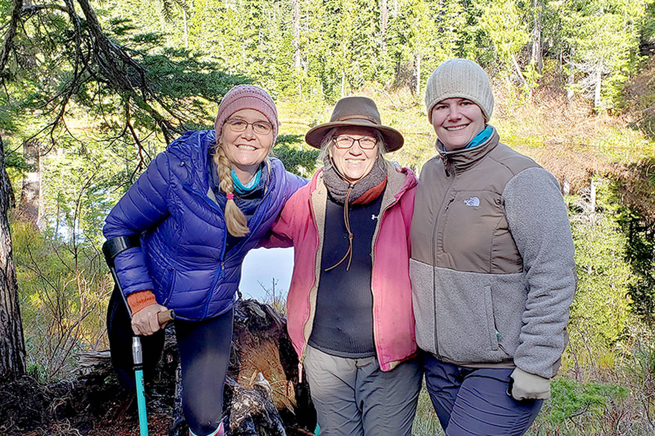 Amputee Dana Lawson, left, celebrates arriving at Deer Lake after a 4-mile trail ride on narrow, steep and rocky terrain  aboard horses and mules with friends Sherry Baysinger, center, and Lindsay Leiendecker. (Larry Baysinger)