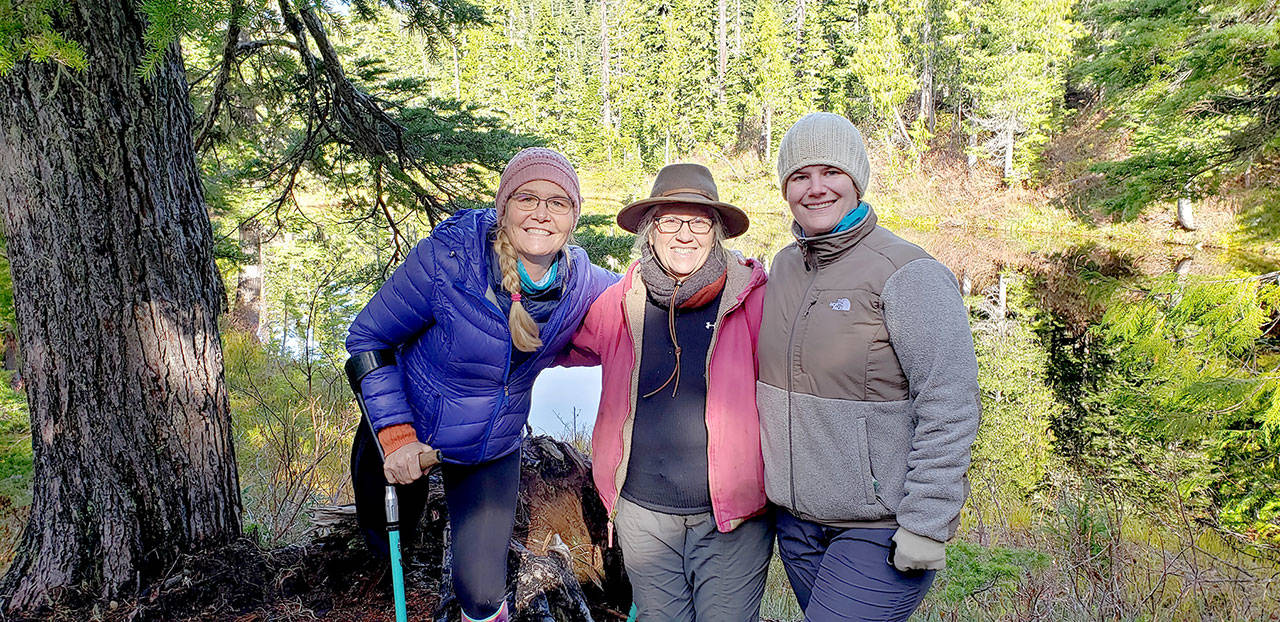 Amputee Dana Lawson, left, celebrates arriving at Deer Lake after a 4-mile trail ride on narrow, steep and rocky terrain aboard horses and mules with friends Sherry Baysinger, center, and Lindsay Leiendecker. (Larry Baysinger)