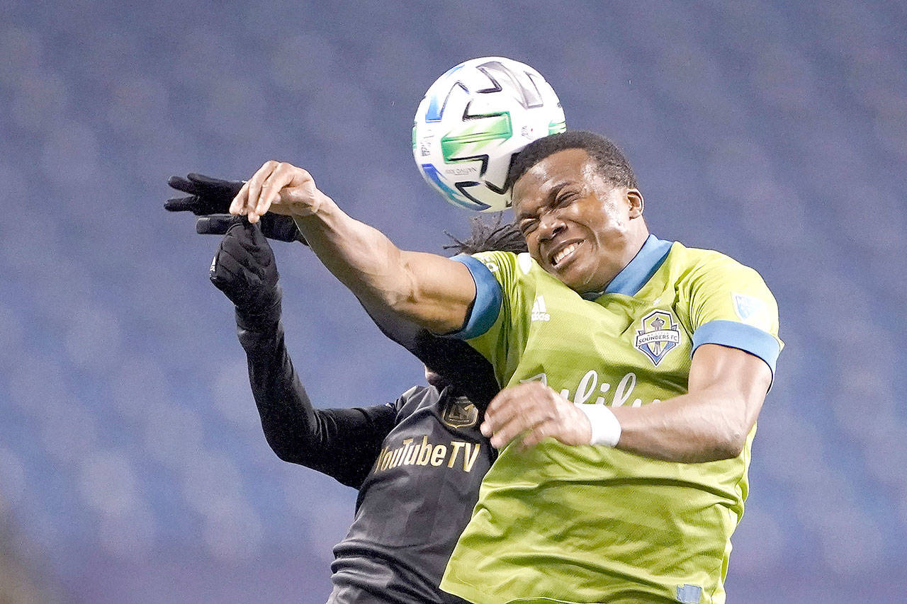 Seattle Sounders defender Nouhou, right, and Los Angeles FC forward Latif Blessing leap to head the ball ball during the second half of an MLS playoff soccer match Tuesday in Seattle. The Sounders won 3-1. (AP Photo/Ted S. Warren)