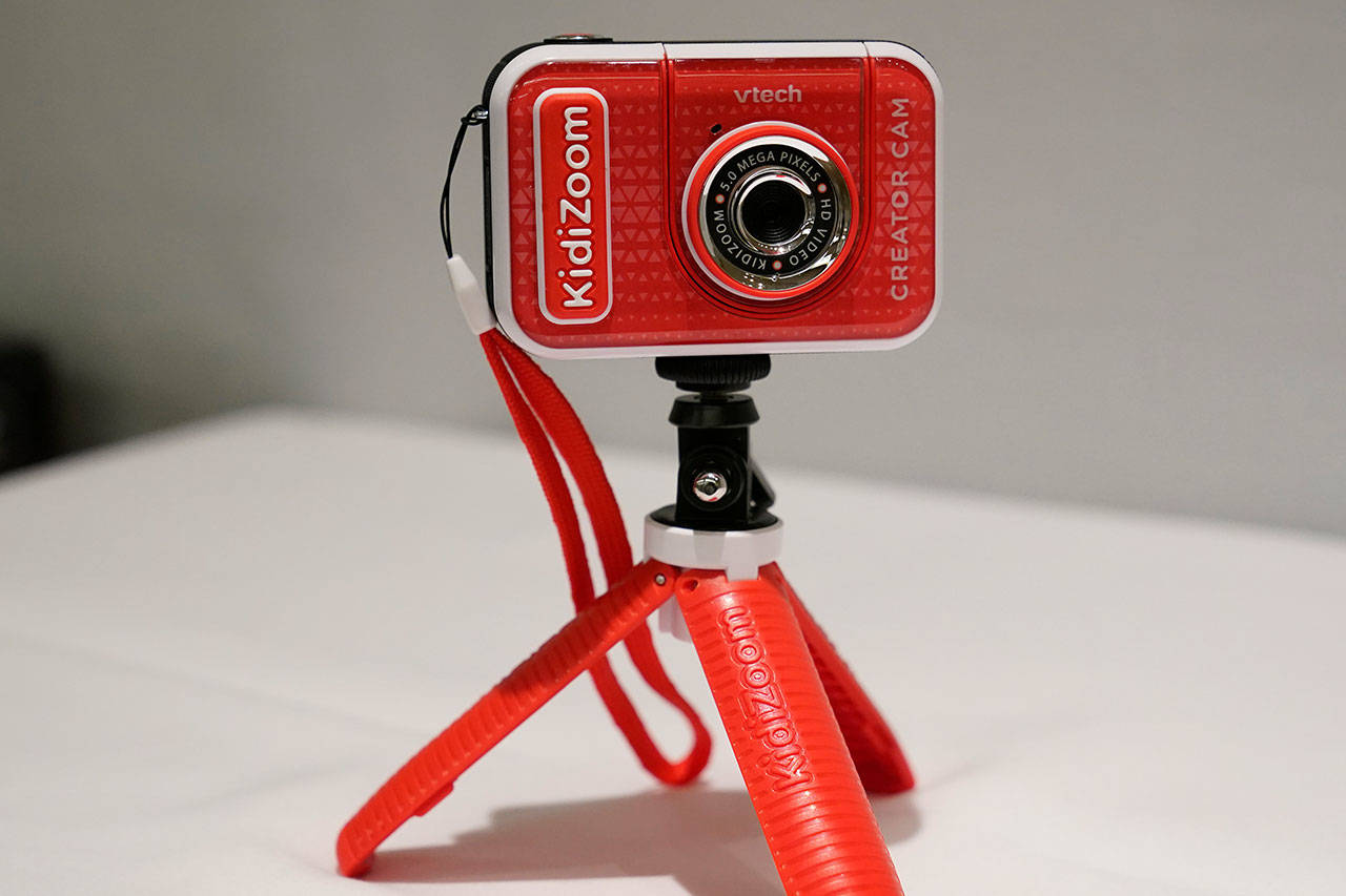 A KidiZoom Creator Cam by VTech is displayed at the Toy Fair on Thursday, Sept. 17, 2020, in New York. The digital camera comes with a green screen and animated backgrounds allowing kids to go to outer space, get chased by T-Rex, or make things disappear. The camera comes with a tabletop tripod, which can also be used as a selfie stick. (Kathy Willens/The Associated Press)