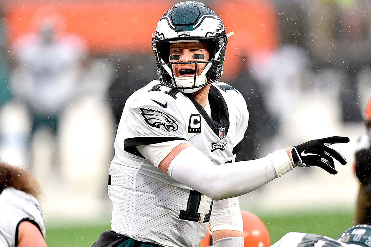Philadelphia Eagles quarterback Carson Wentz (11) stands at the line during an NFL football game against the Cleveland Browns, Sunday, Nov. 22, 2020, in Cleveland. The Browns won 22-17. (AP Photo/David Richard)